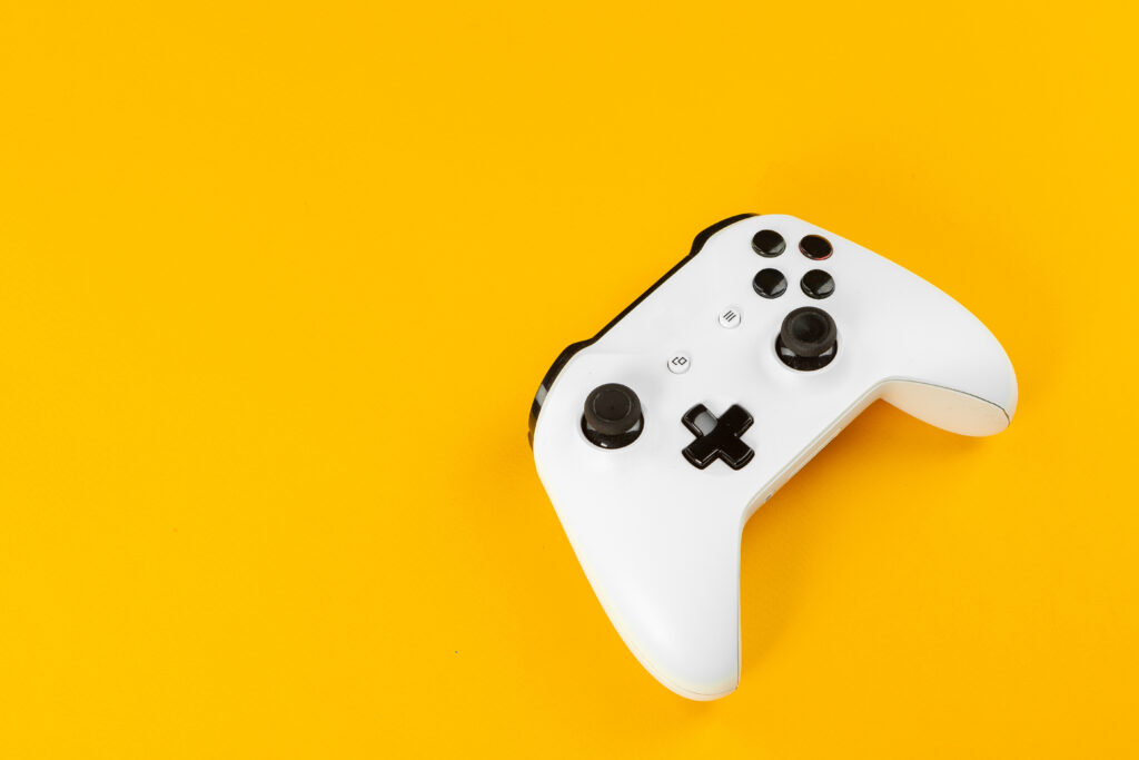 video-game-controller-on-bright-yellow-background-2026-01-08-05-19-32-utc (1)